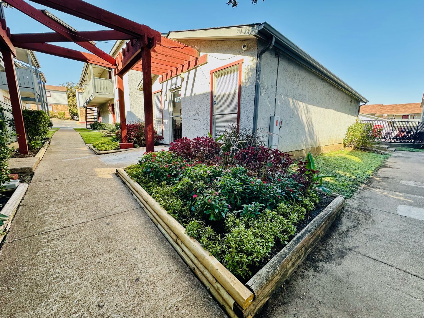 the front yard of a house with a garden and a walkway at The Arlington Park Apartments