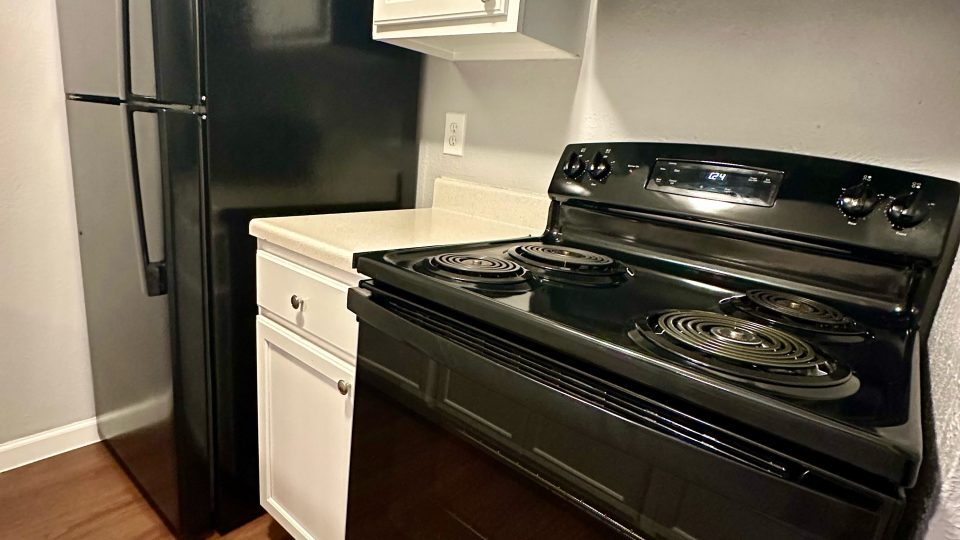 a black stove and oven in a kitchen at The Arlington Park Apartments
