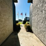 the view of an open doorway with american flags at The Arlington Park Apartments